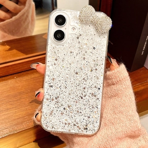 Macro detail of sparkly silver glitter phone case with 3D rhinestone bow decoration
