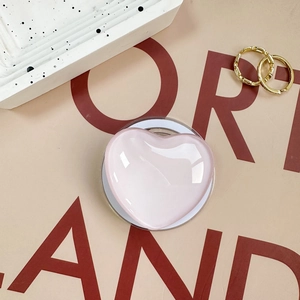 Close-up of a pink heart-shaped phone grip with a translucent jelly-like finish