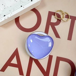 Macro shot of purple heart-shaped telescopic phone grip with smooth glossy resin finish