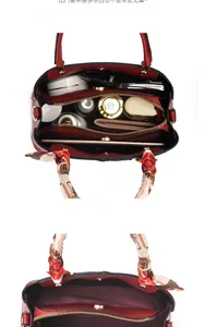 Interior view of the red tote bag showing large capacity and organized compartments