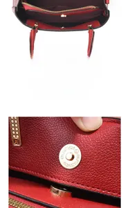 Detail of red lychee grain leather handbag featuring gold magnetic clasp and inner zipper
