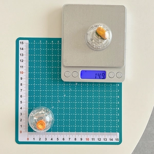 Detailed macro view of miniature food resin burger and egg tart charms for phone grips