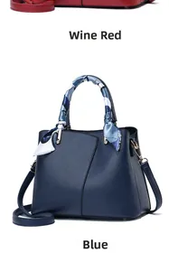 Close-up of litchi grain leather handbag with silk scarf detail and golden hardware