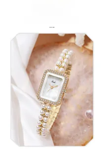 Macro detail of the mother-of-pearl dial and elegant faux pearl bracelet watch