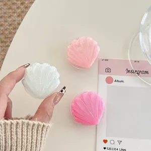 Detailed close-up of shell-shaped glitter phone sockets in white, pink, and rose colors