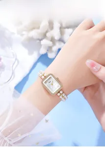 Elegant rectangular gold watch for women featuring white pearl bracelet and shell dial
