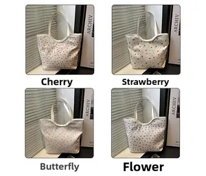 Detail view of four canvas tote bag patterns: cherry, strawberry, butterfly, and flower
