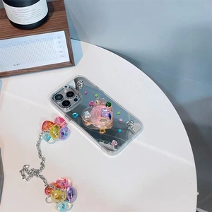 Detail of silver mirror phone case for iPhone with pink heart stand and beaded chain