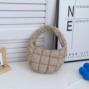 Détail d'un sac nuage matelassé beige avec rembourrage texturé et poignée haute