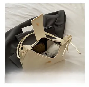 Detail view of the spacious interior of the beige moon bag showing daily essentials