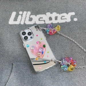 Detail of mirror iPhone case with pink heart popsocket and colorful heart charm chain