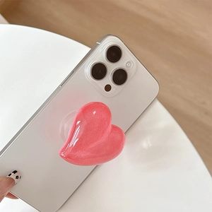 Pink glitter heart cell phone grip socket stand for women with sparkling texture on phone