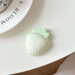 Close-up of a light green 3D strawberry phone grip with realistic textured seed details