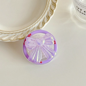 Macro shot of purple holographic laser bow phone grip with Good Luck text details
