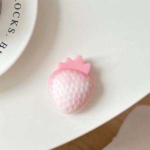 Detailed macro view of 3D pink strawberry phone grip with realistic textured seed finish