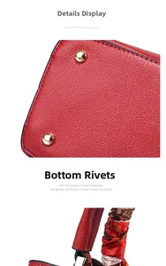 Close-up of red lychee leather bag with gold protective studs and silk scarf handle
