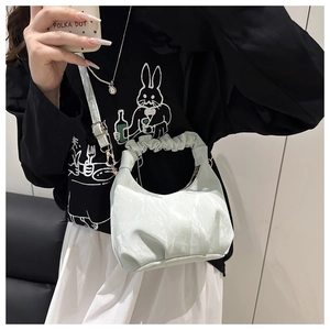 Detail of mint green marble pattern crescent bag with ruched handle and shoulder strap