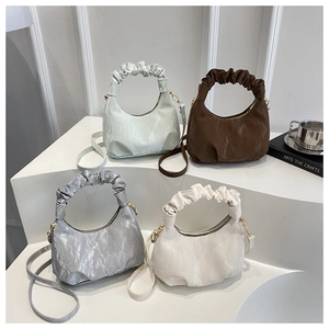 Detailed display of pleated cloud bags in green, coffee, silver grey, and beige finishes