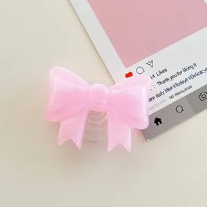 Detail of pink bow phone socket made of glitter resin with a translucent base