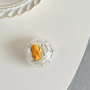 Detail of mini hot dog food model inside transparent globe phone grip with silver beads