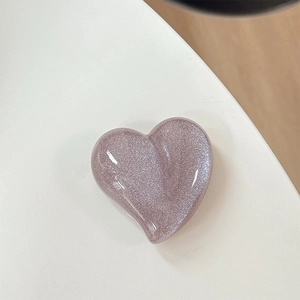 Macro detail of pink glitter heart phone socket with sparkling resin finish