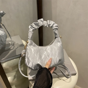 Silver pleated crescent handbag with ruffled handle and detachable shoulder strap