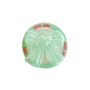 Mint green magnetic laser bow phone grip with heart detail and Good Luck text