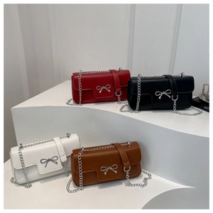 Detail view of four colorful mini square bags with silver bow buckles on white display