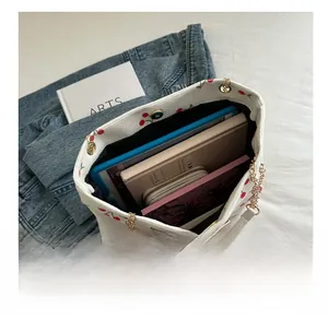 Large white corduroy tote bag with cherry print showing spacious interior capacity