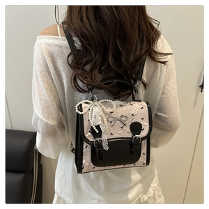 Close-up of sweet style backpack featuring embossed texture and silver bow detail