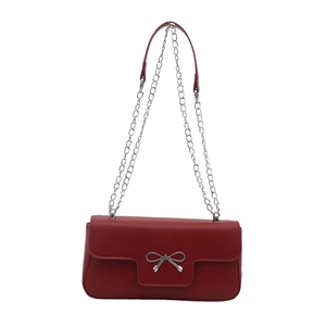 Elegant red faux leather shoulder bag with a silver bow ornament and chain strap