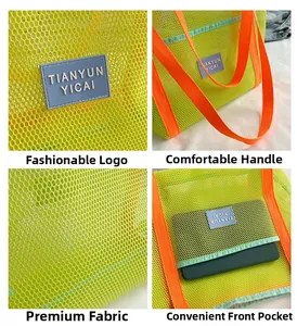 Detail view of neon green mesh beach bag with orange handles and front storage pocket