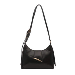 Glossy black half-moon underarm bag with gold hardware and adjustable strap