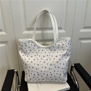 Chic floral tote bag with purple flower patterns and white handles for stylish daily commute