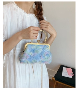 Detail of light blue gradient petal texture bag with gold chain and metal handle