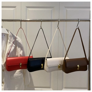 Detail view of minimalist square underarm bags in four colors with gold metal buckles
