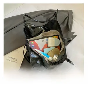 Interior view showing the large storage capacity and zipper pocket of the black tote bag