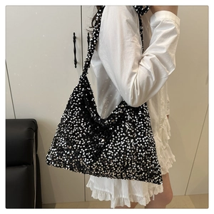 Close-up of black sequin tote bag showing shimmering texture and spacious design