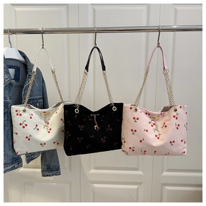 Three corduroy cherry print tote bags in white, black and pink with deer charm details