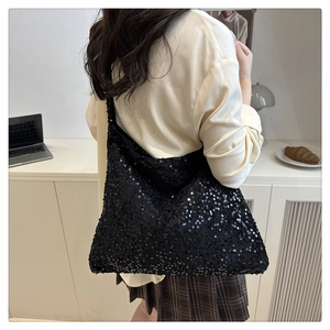 Close-up of black sequined tote bag showing detailed texture and large capacity style