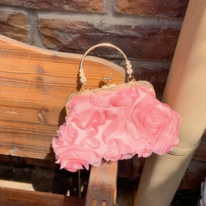 Pink shell-shaped clutch bag with 3D floral petals and elegant gold metal handle