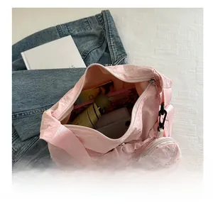 Pink nylon crossbody bag interior showing spacious storage for umbrella and phone