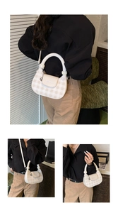 Detail of checkered crossbody bag showing thick circular handle and textured pattern