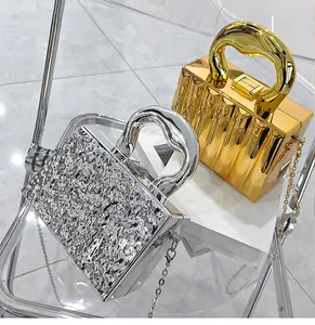 Detail of gold pleated and silver hammered metal evening bags with curved top handles