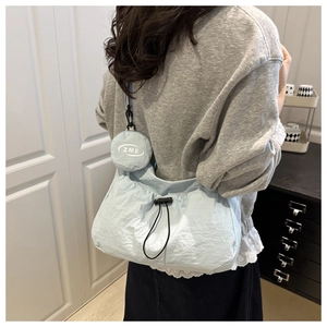 Detail of light blue nylon tote with drawstring and matching round ZME coin purse