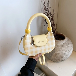 Yellow and white plaid shoulder bag with round handle and adjustable strap