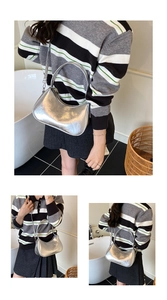 Detailed close-up of silver hobo bag with pleated texture and stylish metal accents