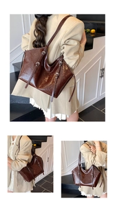Detailed close-up of dark brown glossy tote bag with stylish silver buckle straps