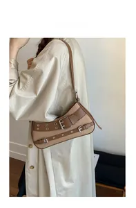 Detailed shot of vintage canvas and brown leather underarm bag with silver buckles