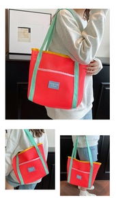 Detail view of colorful mesh beach tote with red body and mint green shoulder straps
